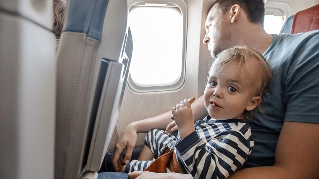 Man with charming infant in plane