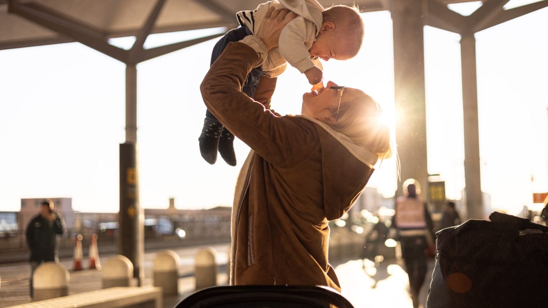 Mother-holding-baby-at-airport
