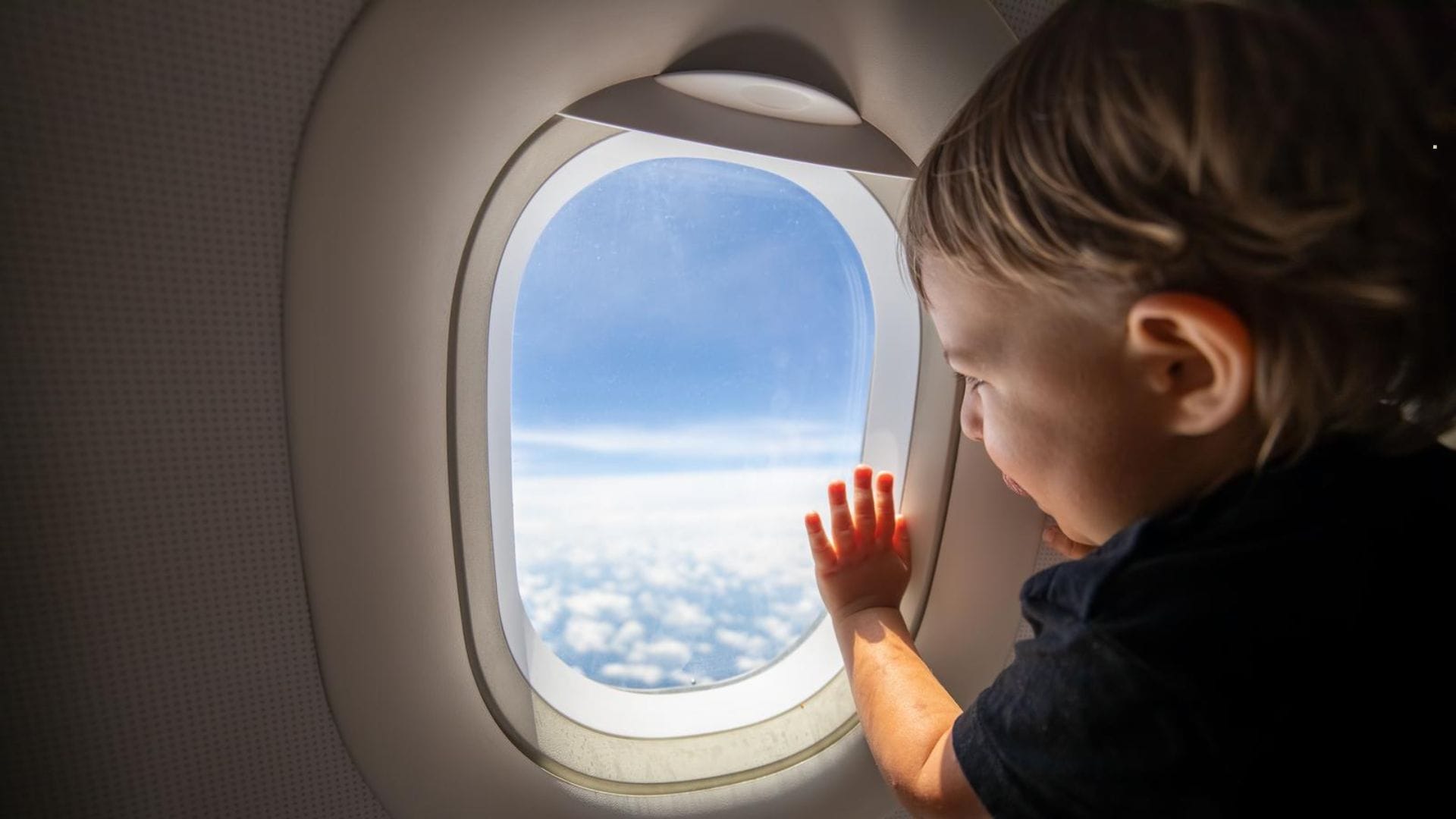cute-toddler-points-his-finger-at-the-sky-through-the-window
